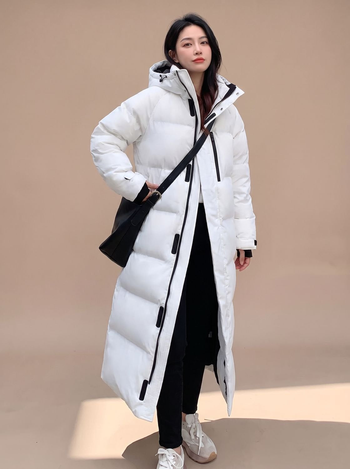 Daunenjacke Damen lang im Oversize-Schnitt mit Kapuze